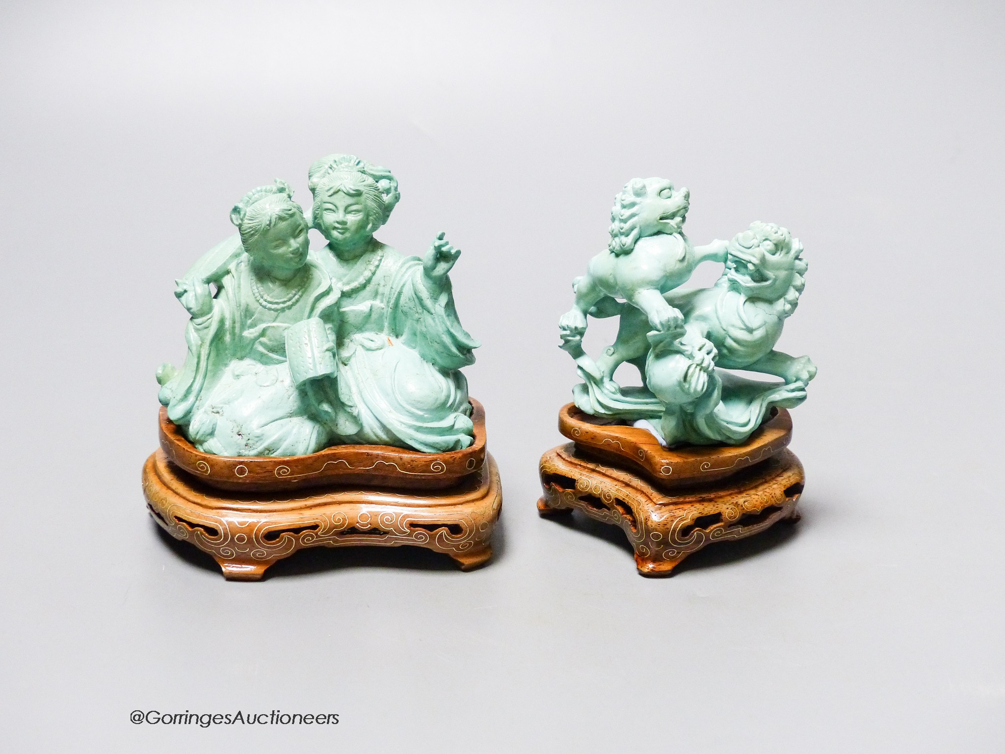 Two Chinese turquoise matrix groups of lion-dogs and of two kneeling ladies, mid 20th century, wood stands, height 9cm